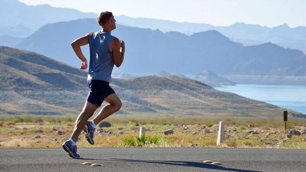 Runner burning fat by running on road