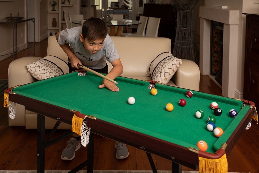 a small pool table in a living room