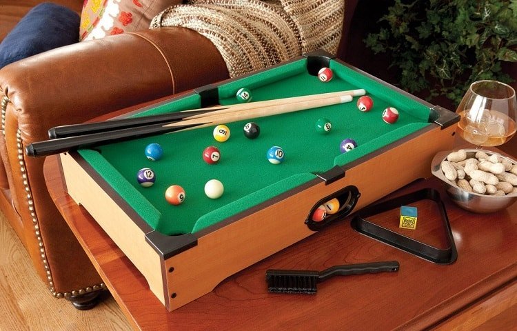 mini billiard table next to sofa