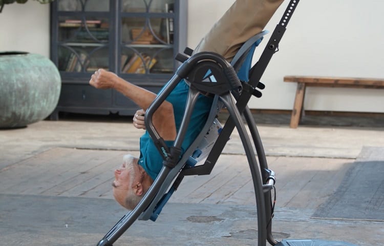 man upside down on inversion table