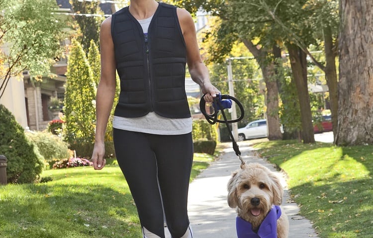 woman walking dog with weighted vest